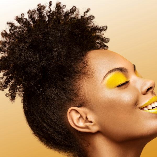 Beautiful natural curly afro puff with tight, defined curls, enhanced with Remember Me Styling Foam for volume and texture by Evolving Textures.