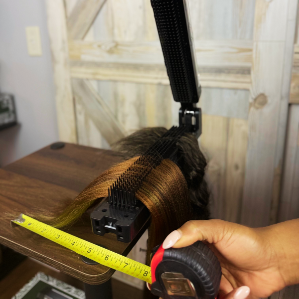 Measuring braiding hair extensions on the Alli Styles Assistant, highlighting the precision and control this professional braiding tool provides.