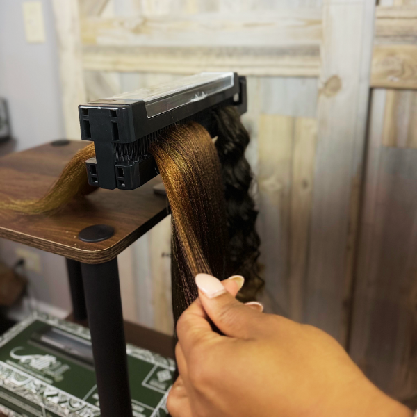 Smooth hair pull-through technique using the Alli Styles Assistant, showing the tool's comb-like teeth gripping the hair securely for clean, even sections.